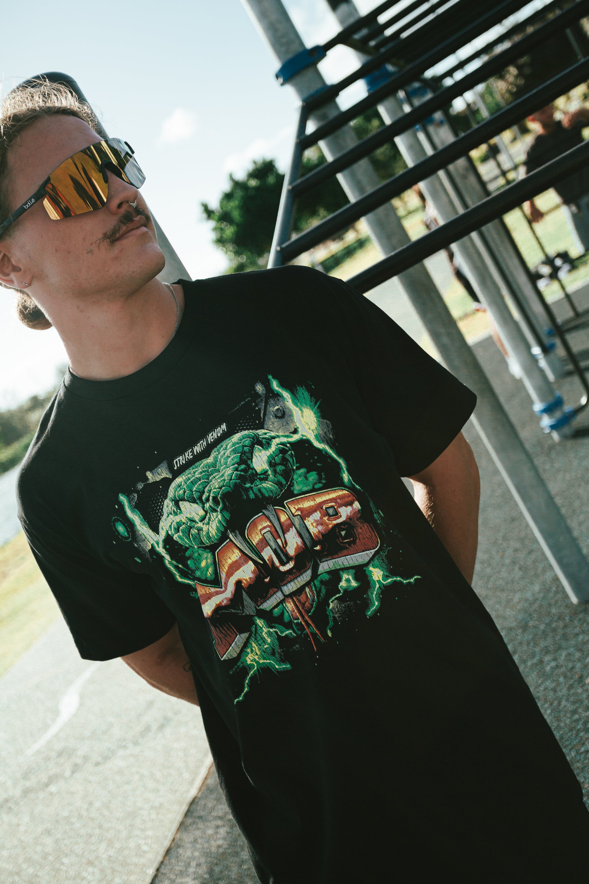 Person wearing a black t-shirt with a graphic design outdoors